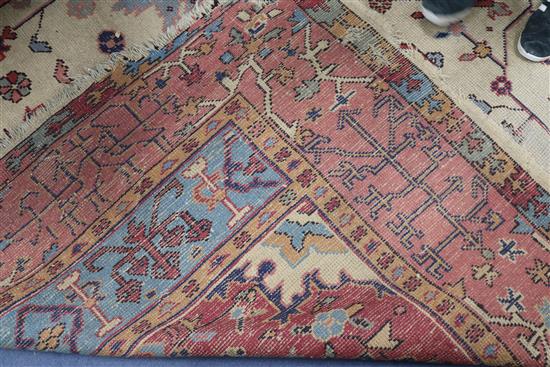 A Turkey pink and cream medallion carpet (worn in places and frayed at one end) 410 x 313cm